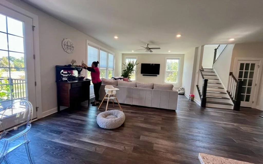 experienced cleaning fairy vacuuming spacious living area